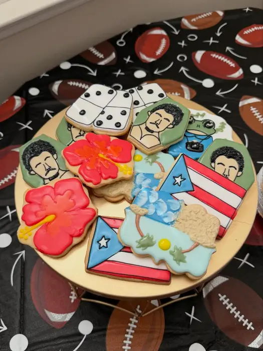 Super Bowl cookie set with Puerto Rican flags, hibiscus flowers and portrait cookies on a football backdrop