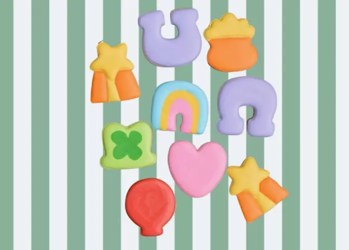 Pastel cookie shapes including a horseshoe, rainbow, balloon, heart, clover and star
