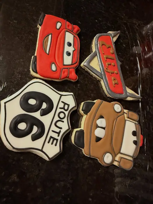 Cars themed cookie set arranged on a glass stand