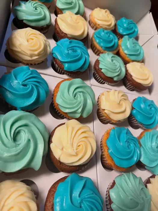 Boxes of blue and cream swirled cupcakes