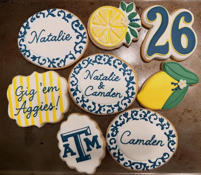 Texas A&M graduation cookies for Natalie and Camden with lemons and blue scrollwork