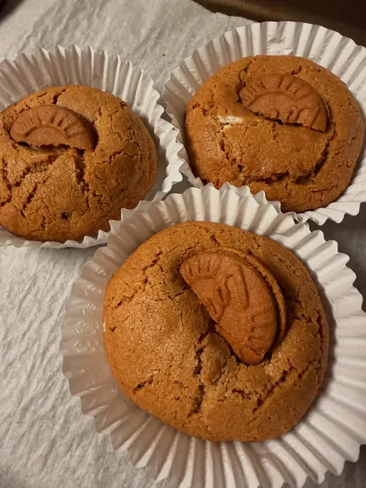 Three Biscoff cookies in paper cases, each topped with a Biscoff biscuit