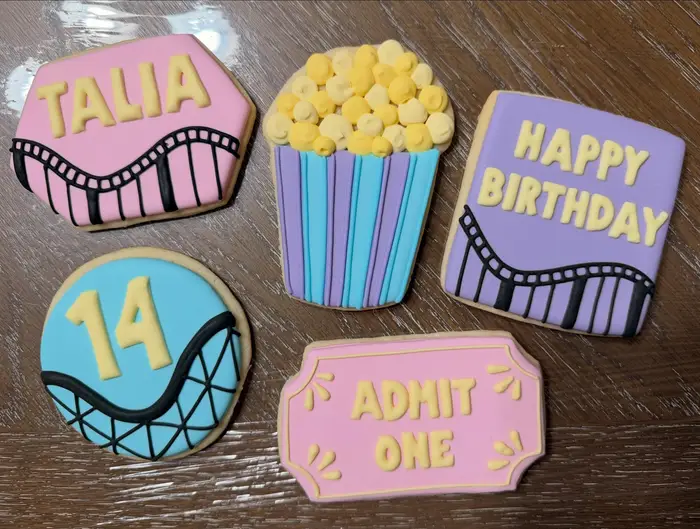 Rollercoaster themed cookies: a popcorn box, an Admit One ticket and a number 14
