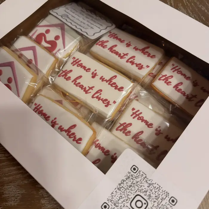 Boxed cookies reading "Home is where the heart lives" with a house and heart logo