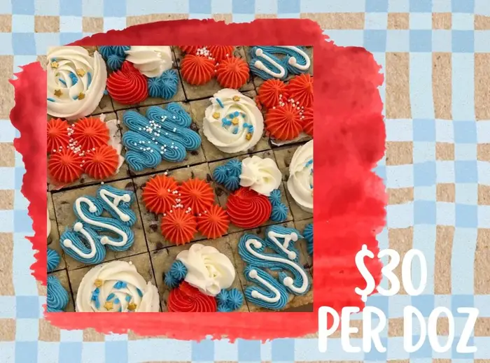 Brownies iced with USA lettering and red and blue rosettes