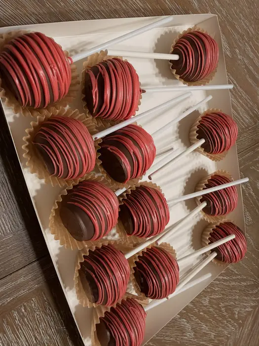 Chocolate cake pops finished with red drizzle
