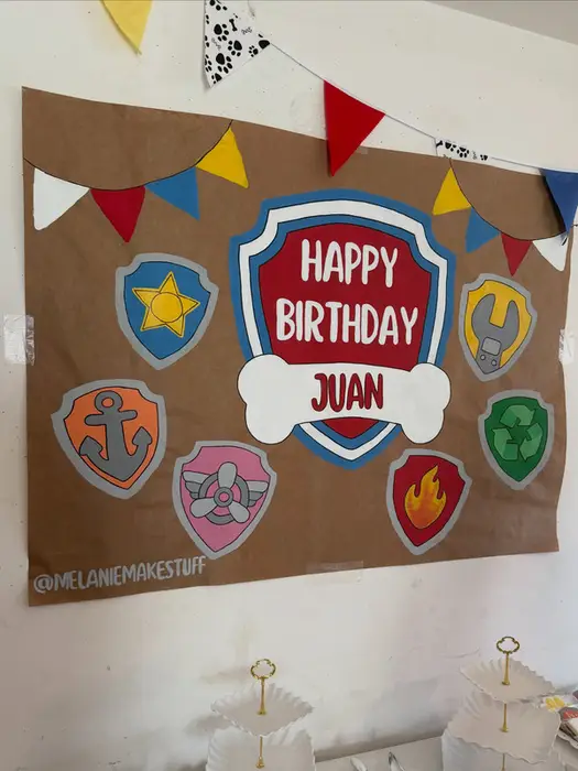 Hand-painted Paw Patrol "Happy Birthday Juan" poster with badges and bunting