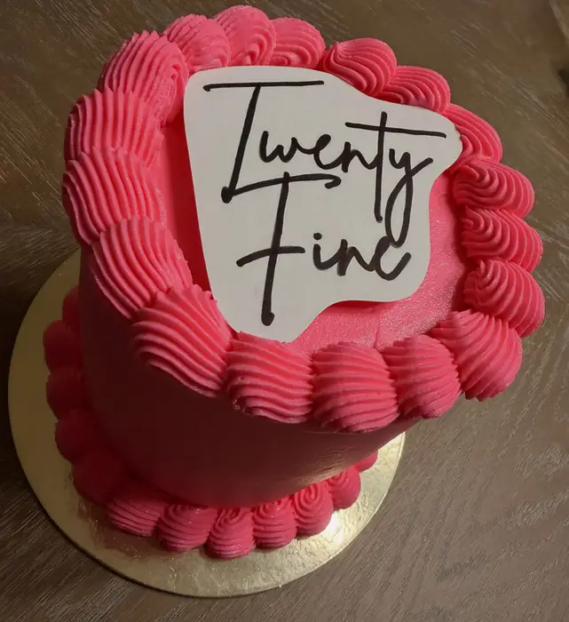 The "Twenty Fine" pink birthday cake seen from the side