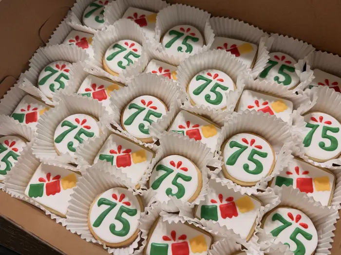 75th birthday cookies with green numerals and little gift designs