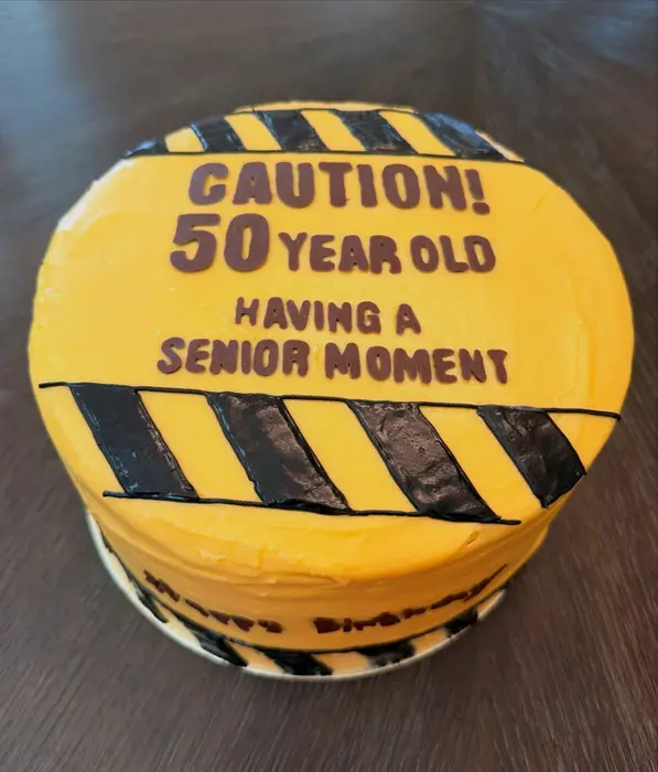 Top view of the caution tape 50th birthday cake