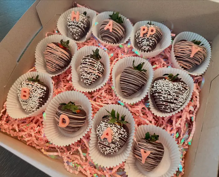 Chocolate dipped strawberries decorated with drizzle and pearls