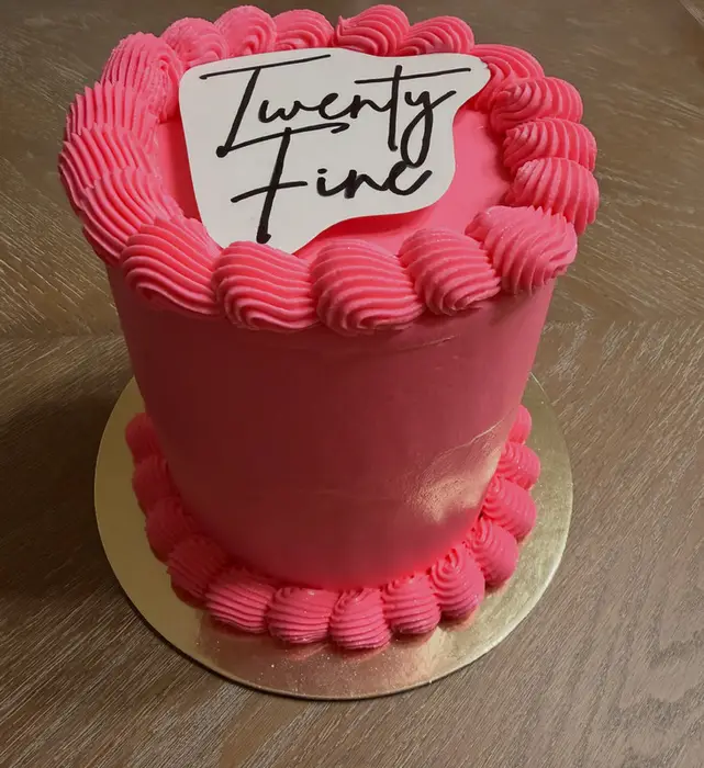 The hot pink "Twenty Fine" cake on a gold board