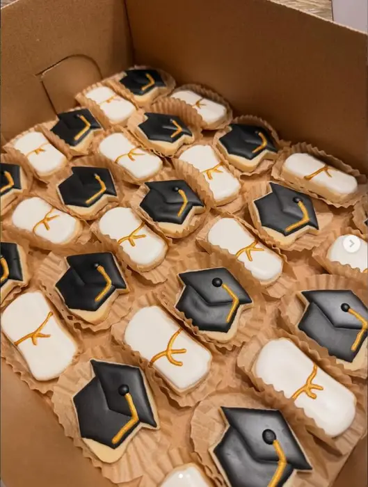 Trays of mini graduation cap and diploma cookies