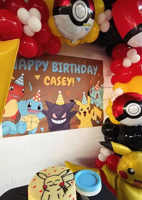 Hand-painted Pokemon "Happy Birthday Casey!" poster surrounded by balloons